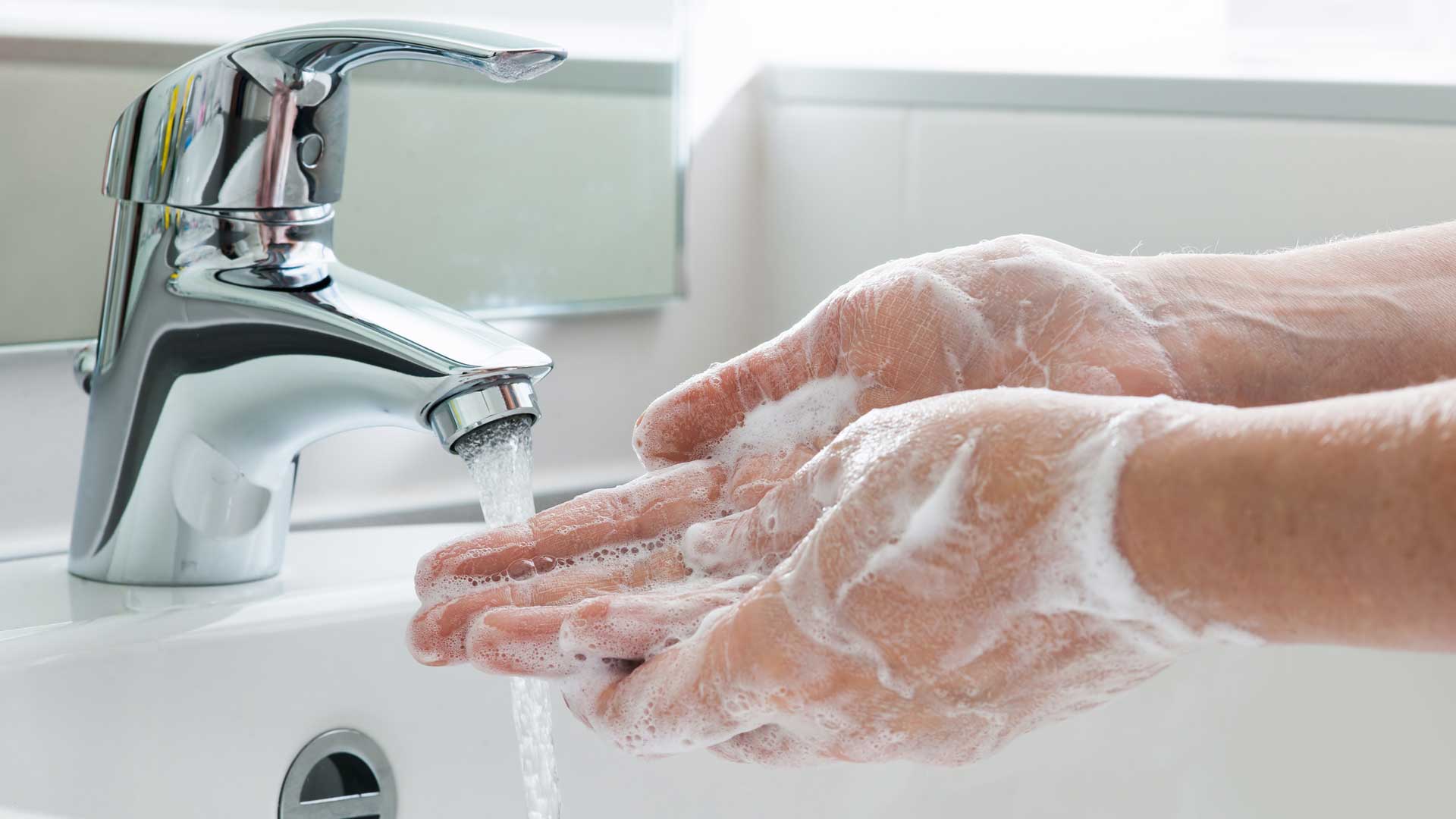 A person washing their hands with soap